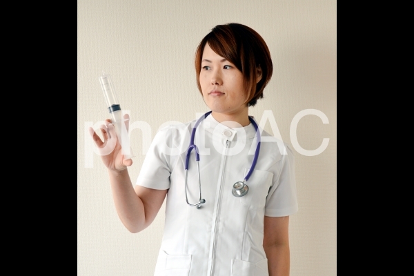 注射器を持つ看護師 注射器を持つ看護師の写真