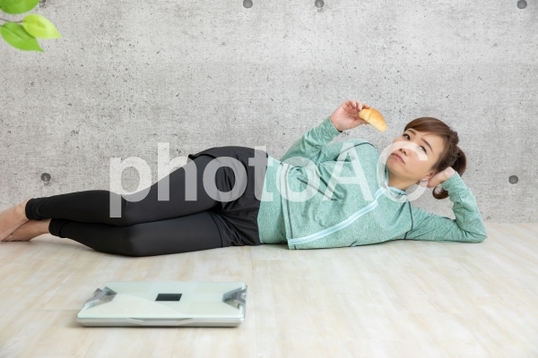 ダイエットをサボる女性 ダイエットをサボる女性の写真