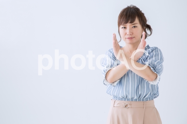 バツのジェスチャーをする女性 バツのジェスチャーをする女性の写真